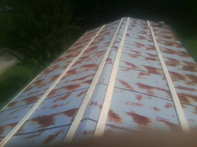 Rusted metal roof panels with new wood purlins before replacement — Storm Damage Roof Repair in Eufaula by Roofing Brothers